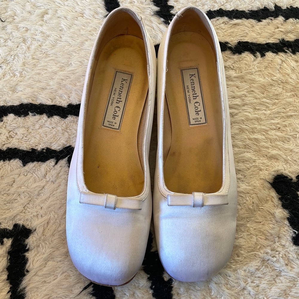 Kenneth Cole wedding shoes. White satin. They’re stiff like toe shoes.